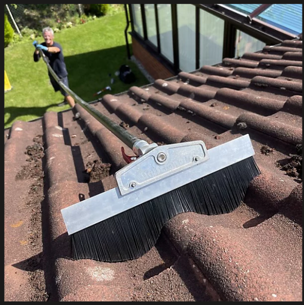 Roof moss removal equipment on roof tiles